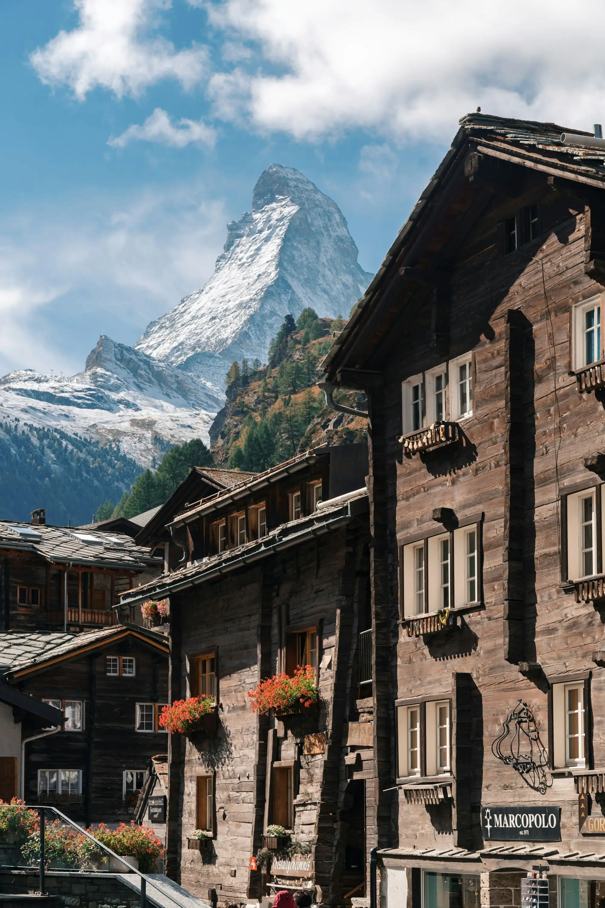 Wooden chalets in Zermatt beneath the snowy Matterhorn, Swiss Alps