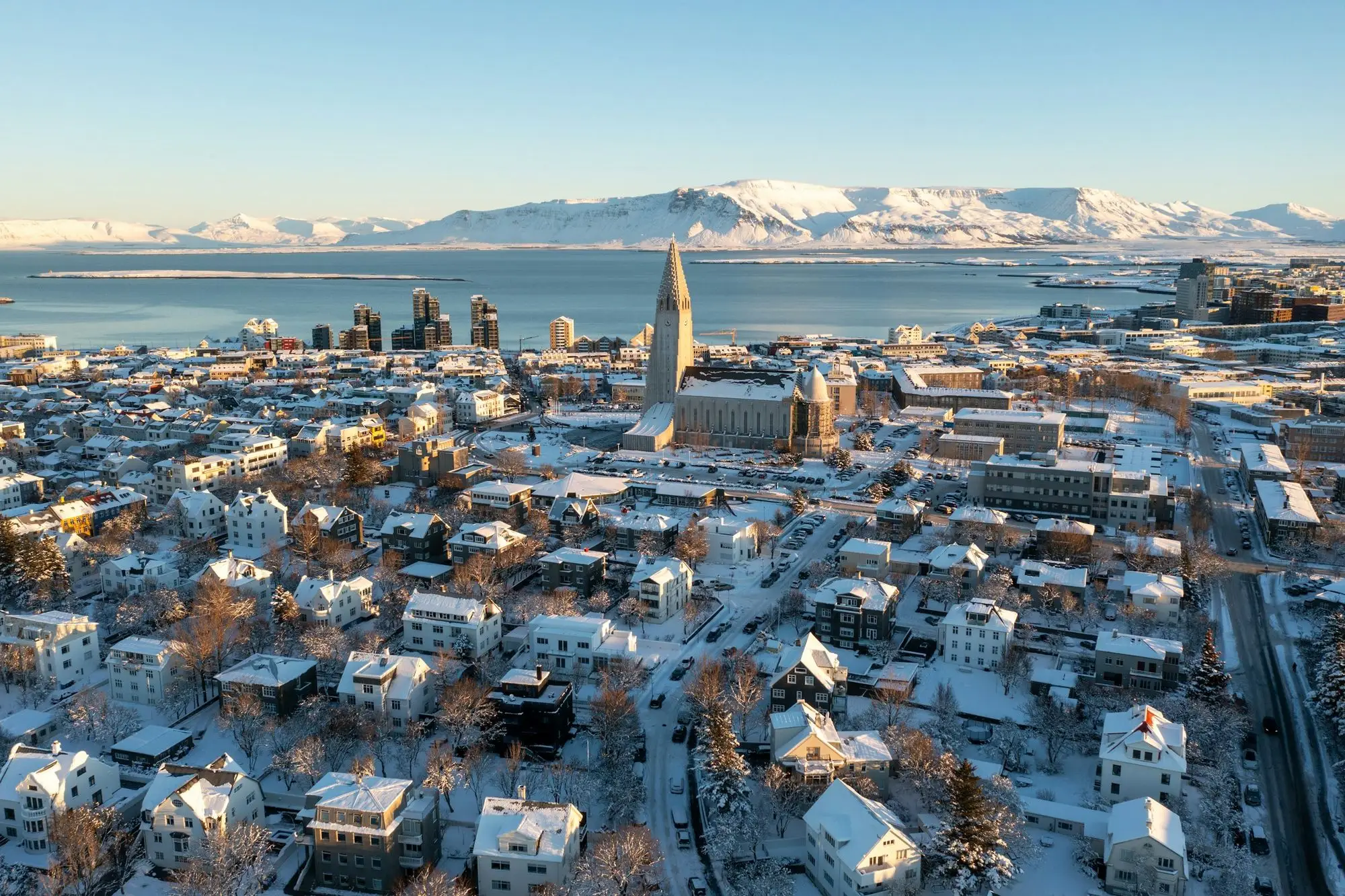 An aerial view of snowy Reykjavík rooftops in winter